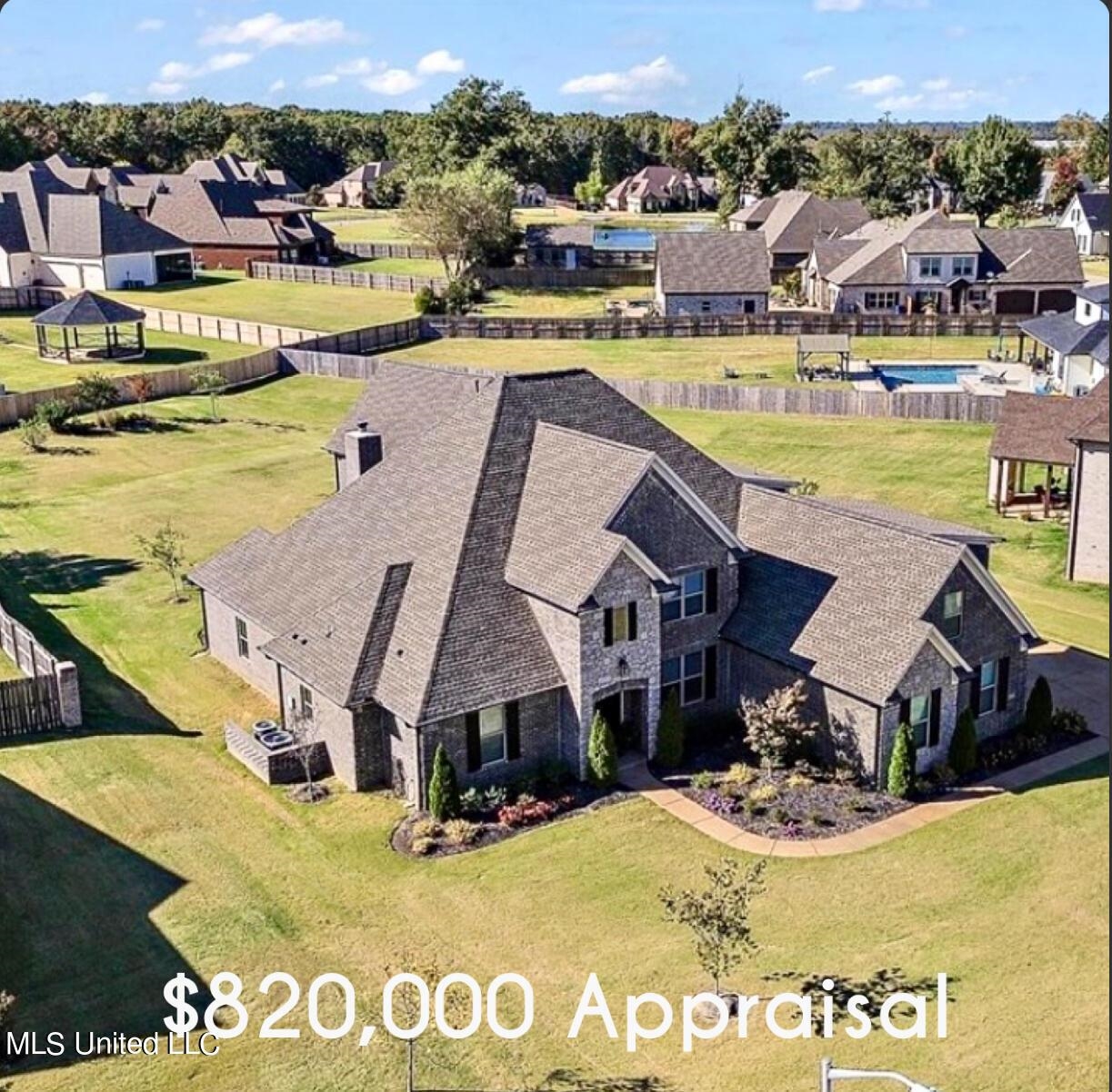 an aerial view of a house with a swimming pool