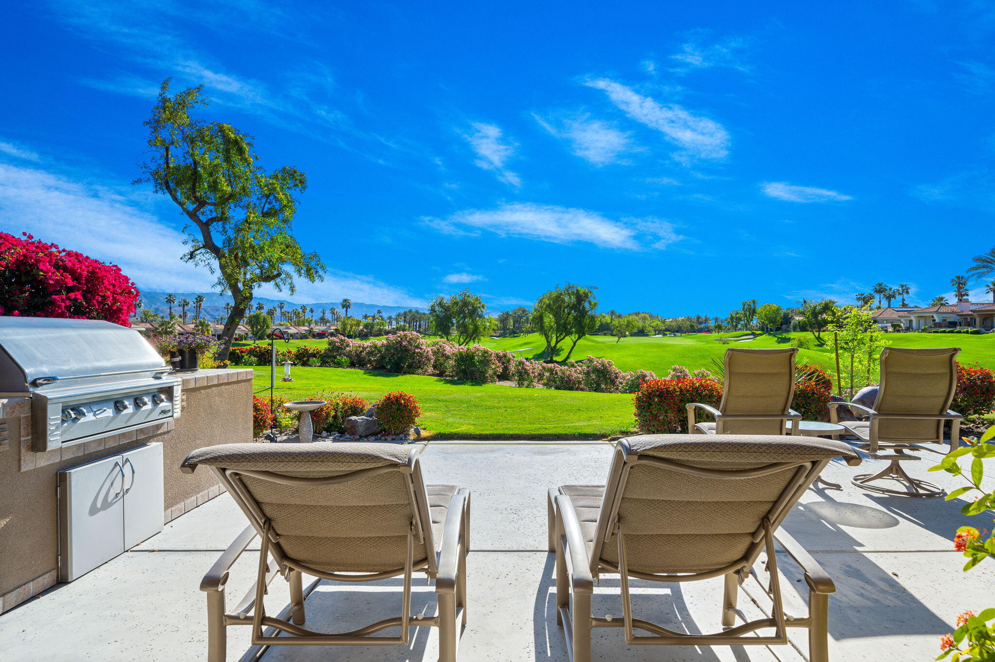 a view of a chairs and table in a patio