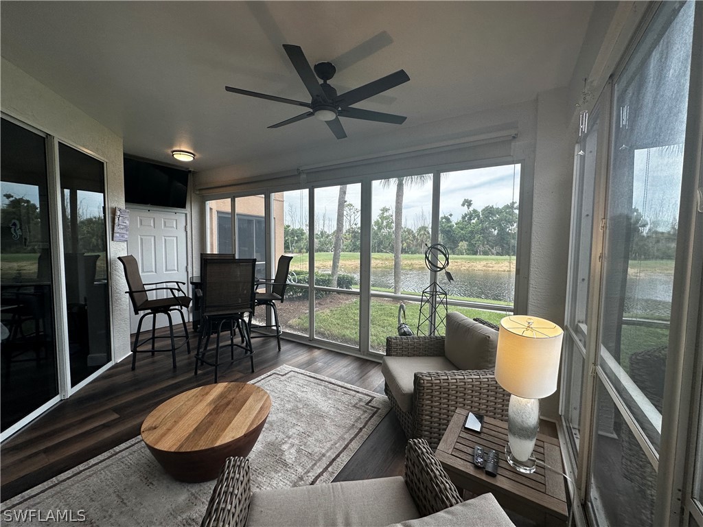 a living room with furniture and a floor to ceiling window