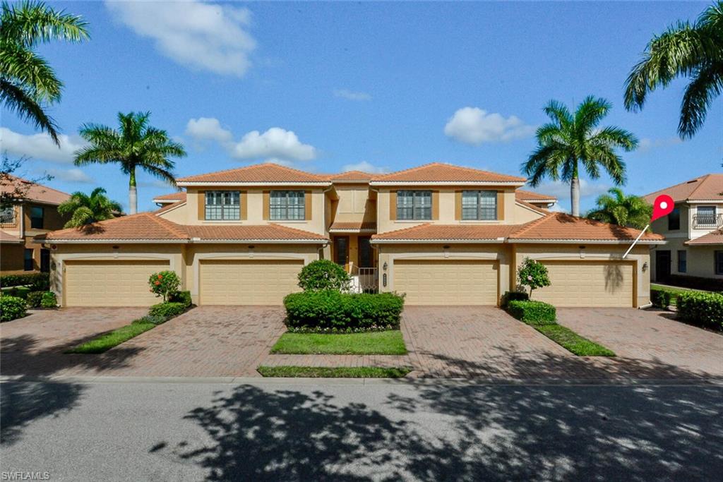 a front view of a house with a yard and a garage