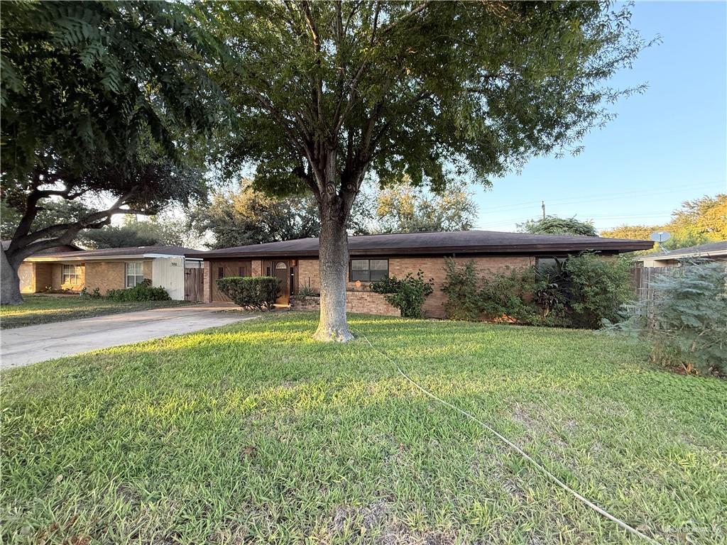 Ranch-style home featuring a front lawn