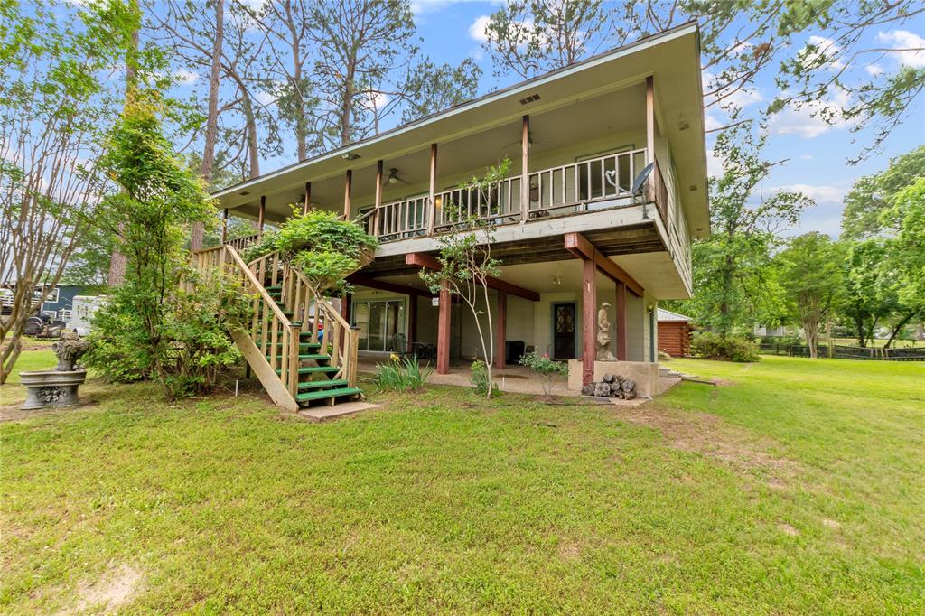 a view of a house with a yard and sitting area