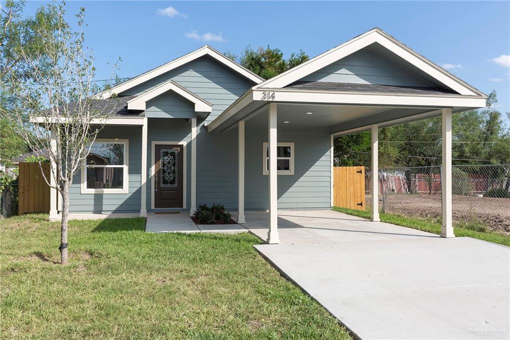 a view of a house with a yard and porch