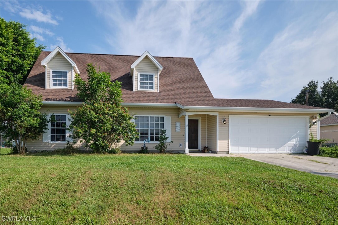 a front view of house with yard and green space