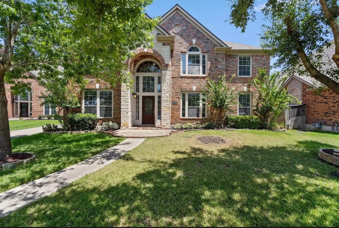 a front view of a house with a yard