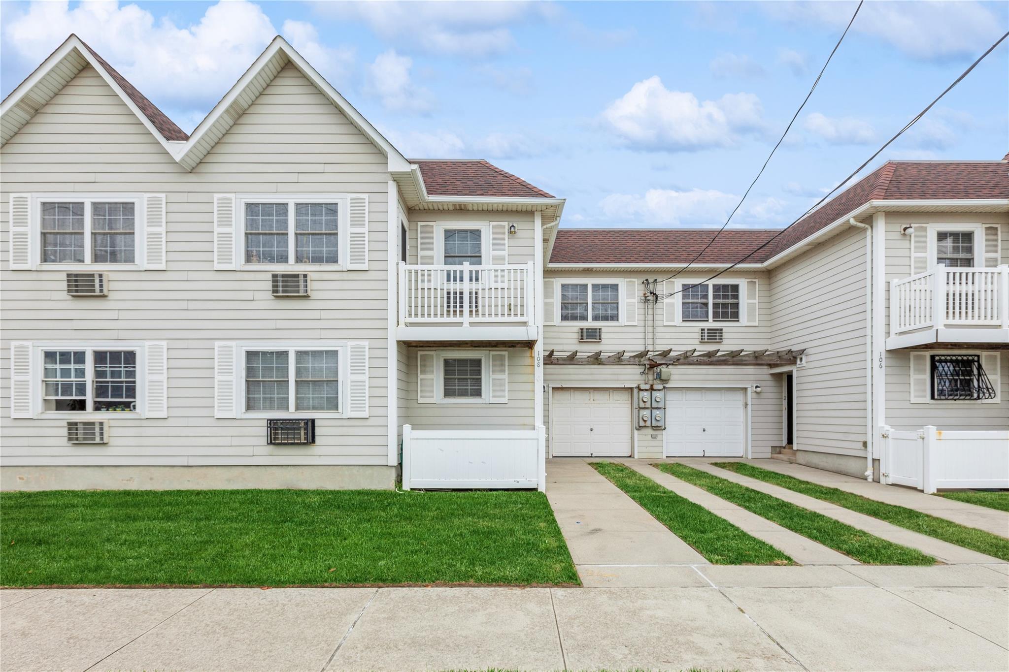 View of front of house with a garage and a front yard