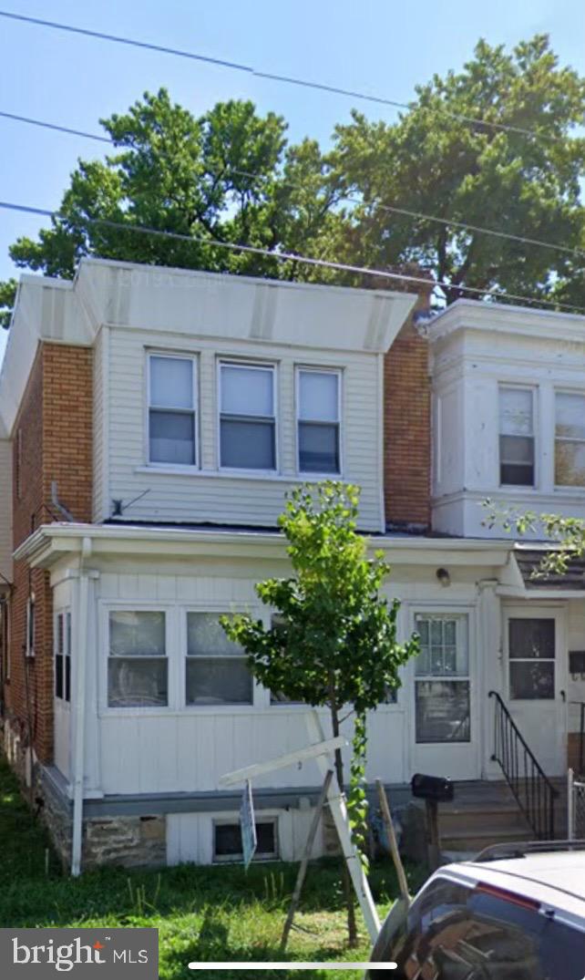 a aerial view of a house with a yard and potted plants