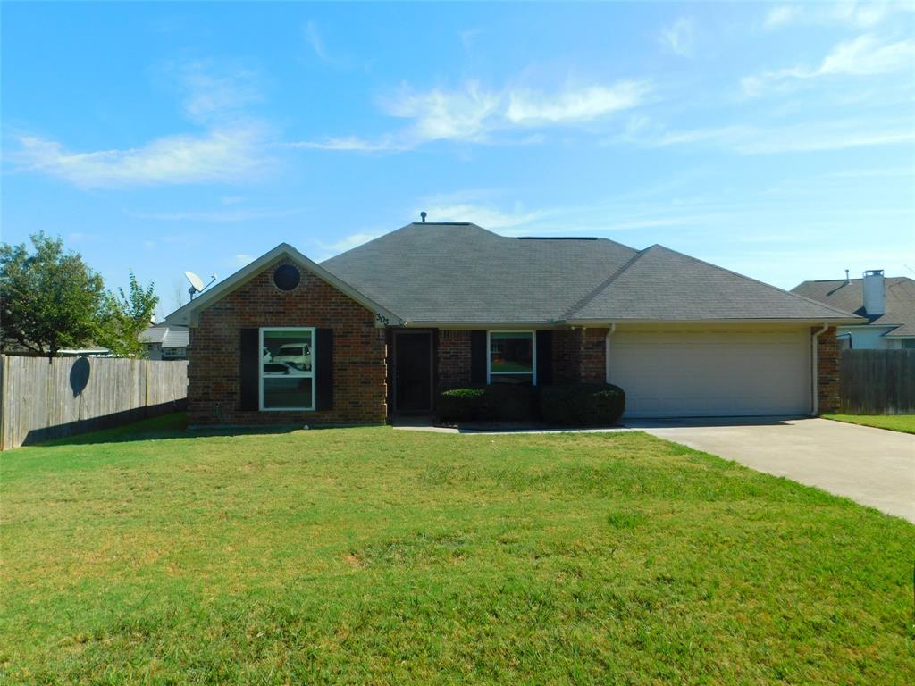 a front view of a house with yard and road