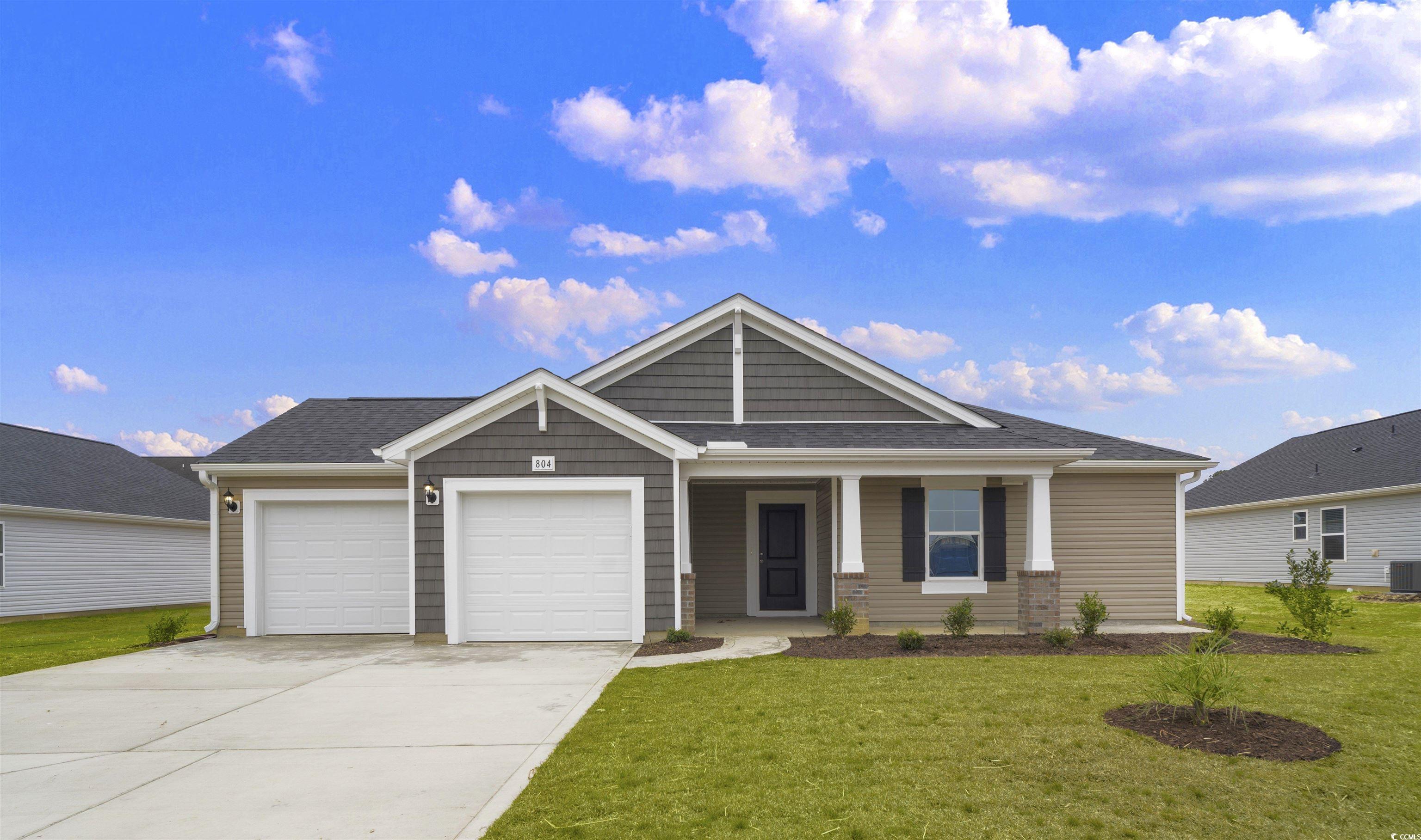 View of front of home featuring covered porch, a g