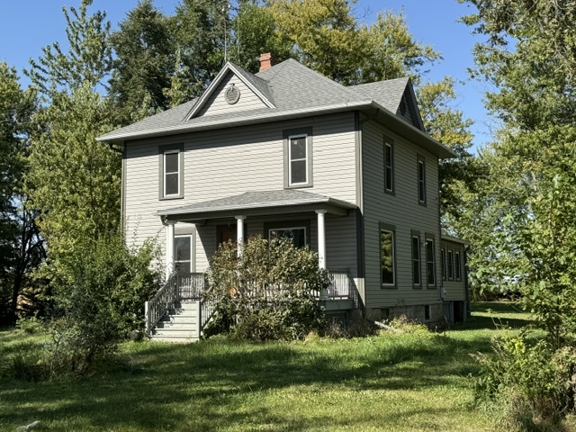 a front view of a house with a yard garage and outdoor seating