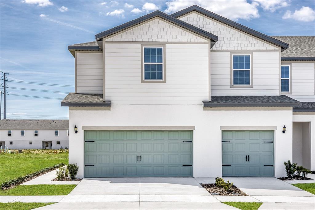 a front view of a house with a garage