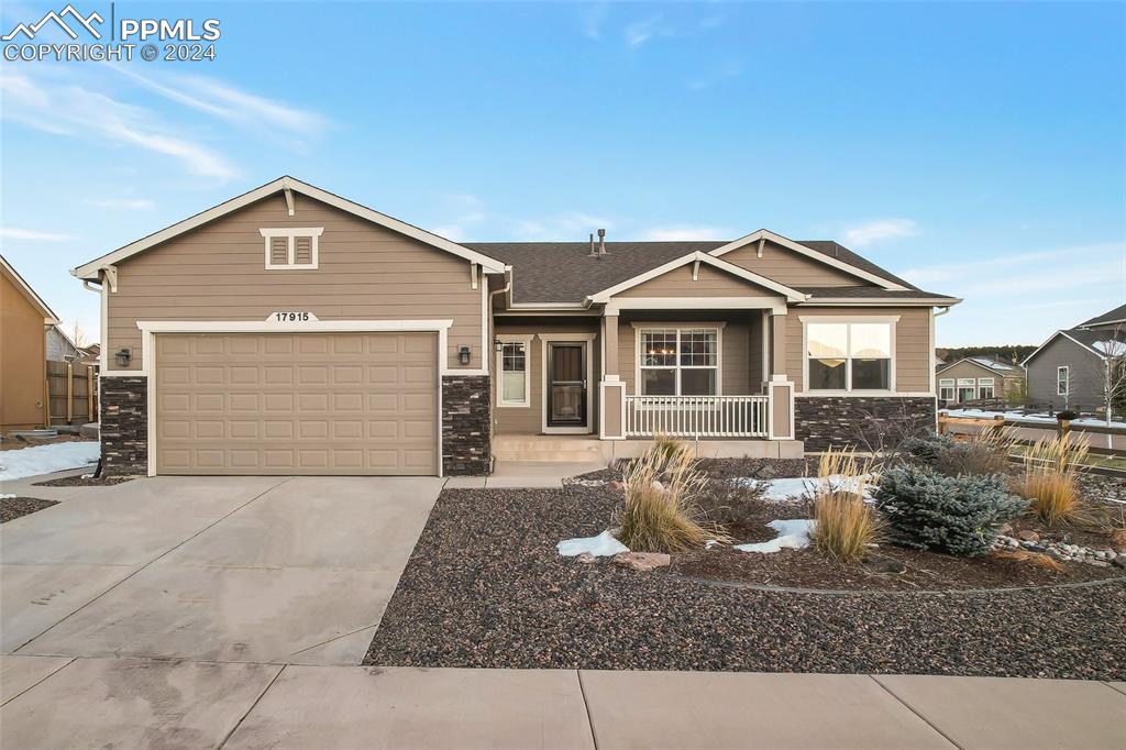 a front view of a house with yard and parking space