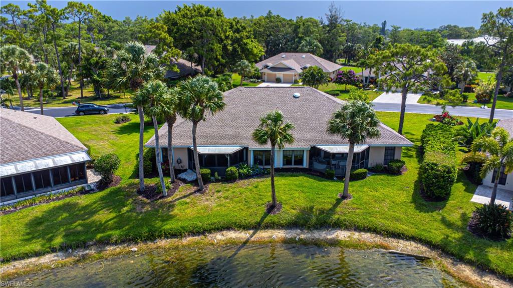 an aerial view of a house with swimming pool and garden