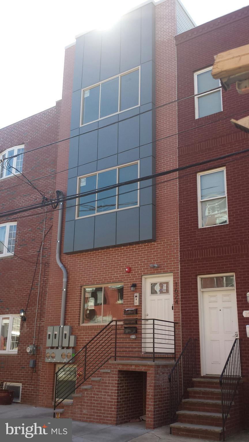 a view of a brick building with many windows