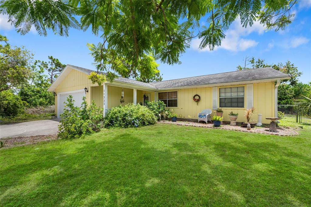 a view of a house with backyard sitting area and garden