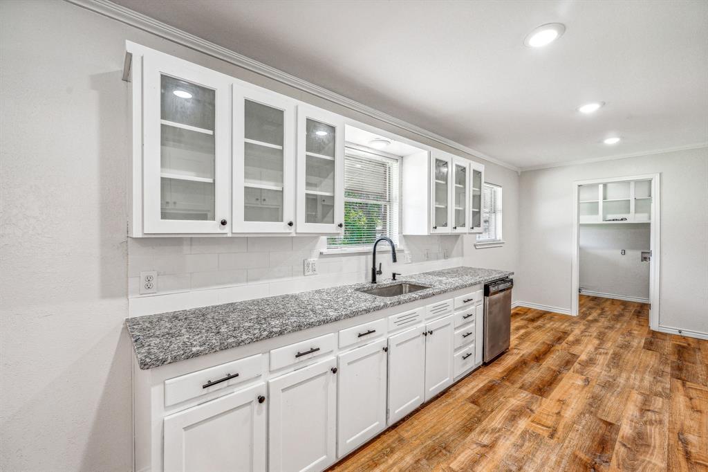 a view of a kitchen with granite countertop cabinets stainless steel appliances a sink and a window