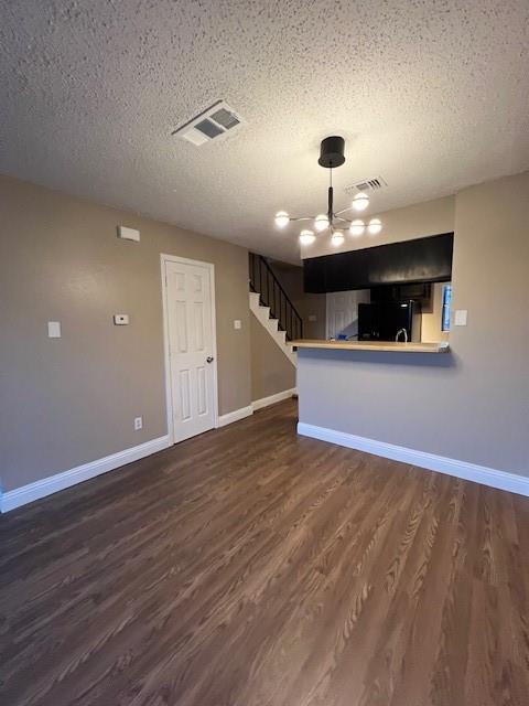 a view of a room with wooden floor and a ceiling fan