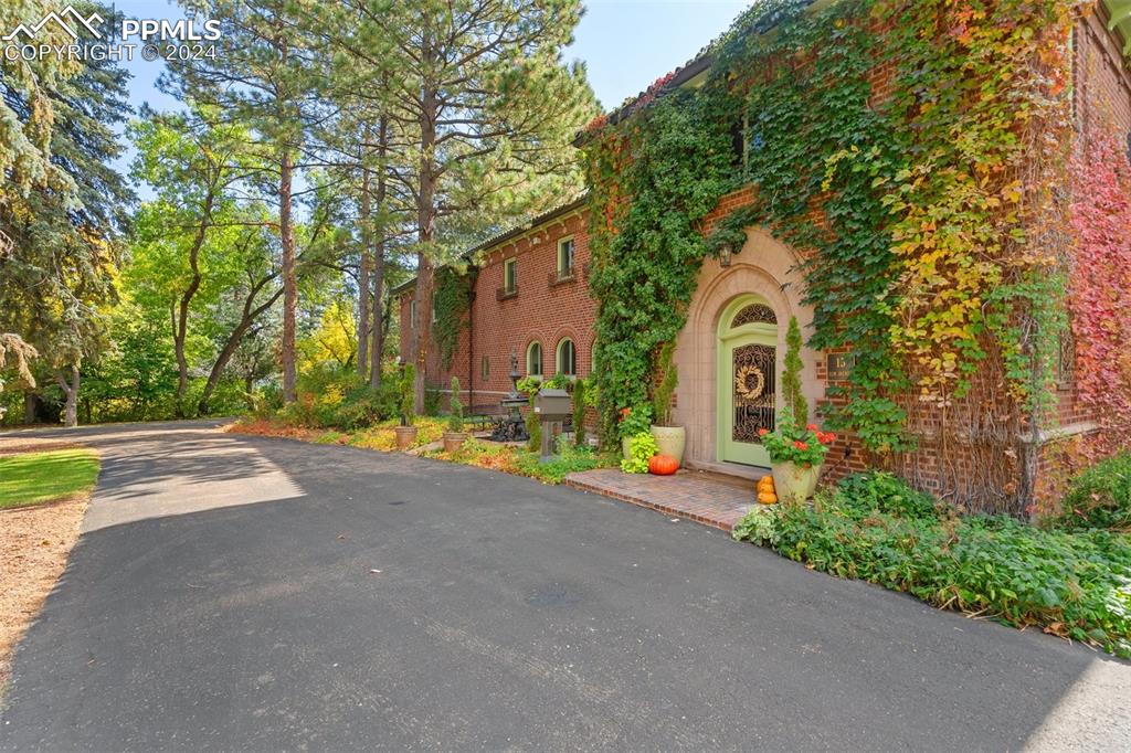 a front view of a house with a garden