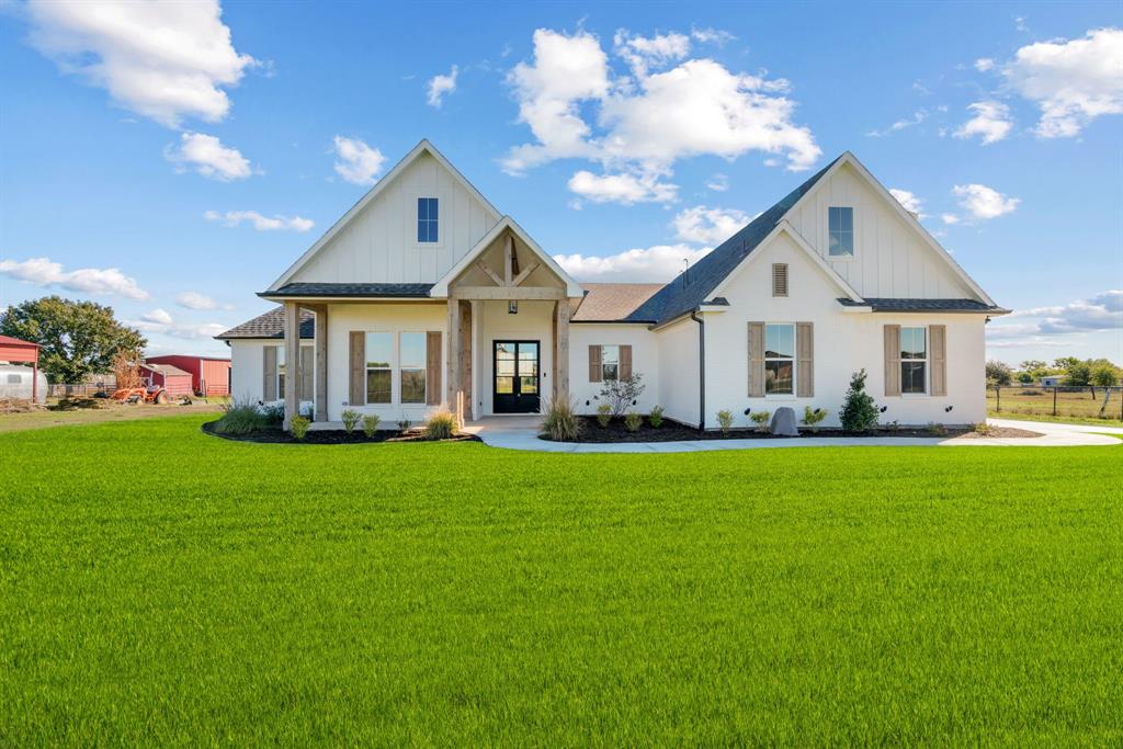 a front view of a house with a garden and porch