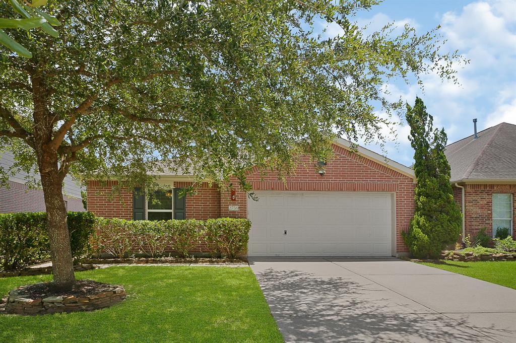 a front view of a house with a yard and a garage