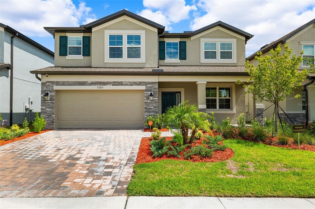 a front view of a house with a yard and garage