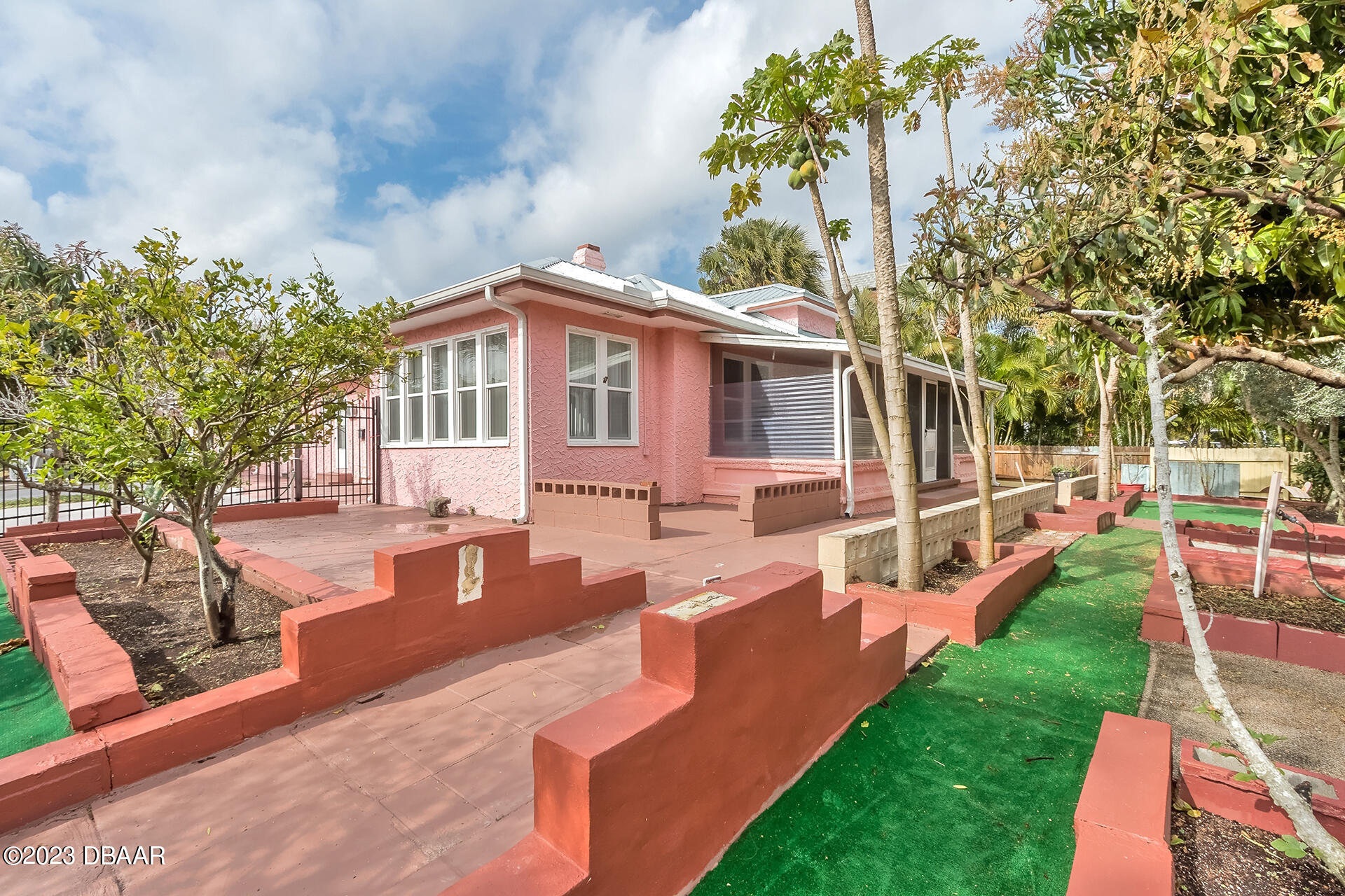 a view of a house with a yard patio and swimming pool