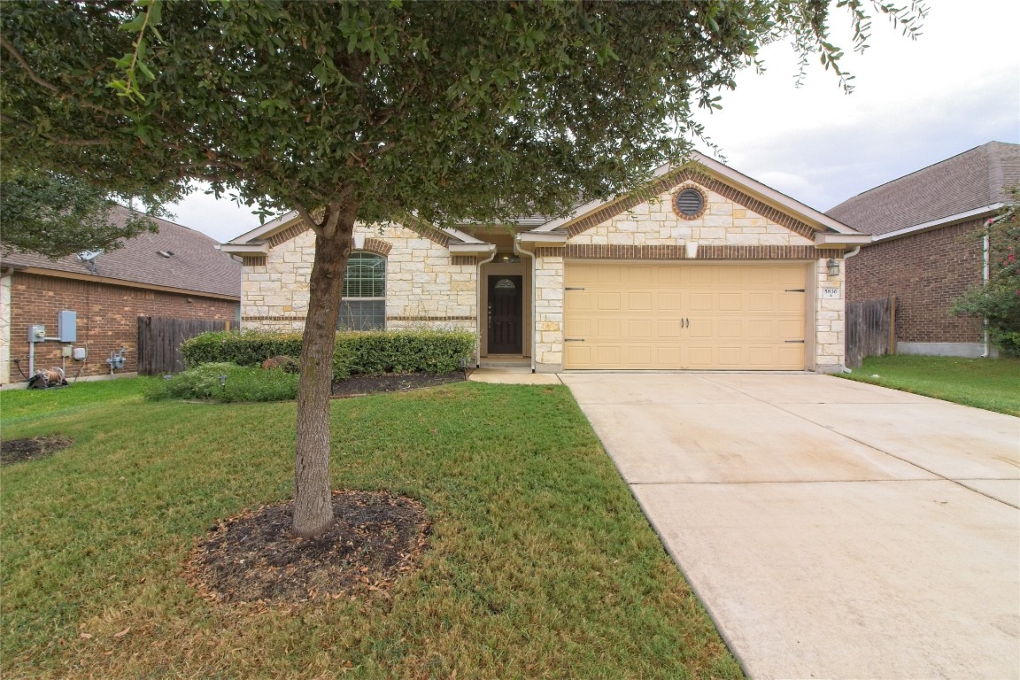 a front view of house with yard and green space