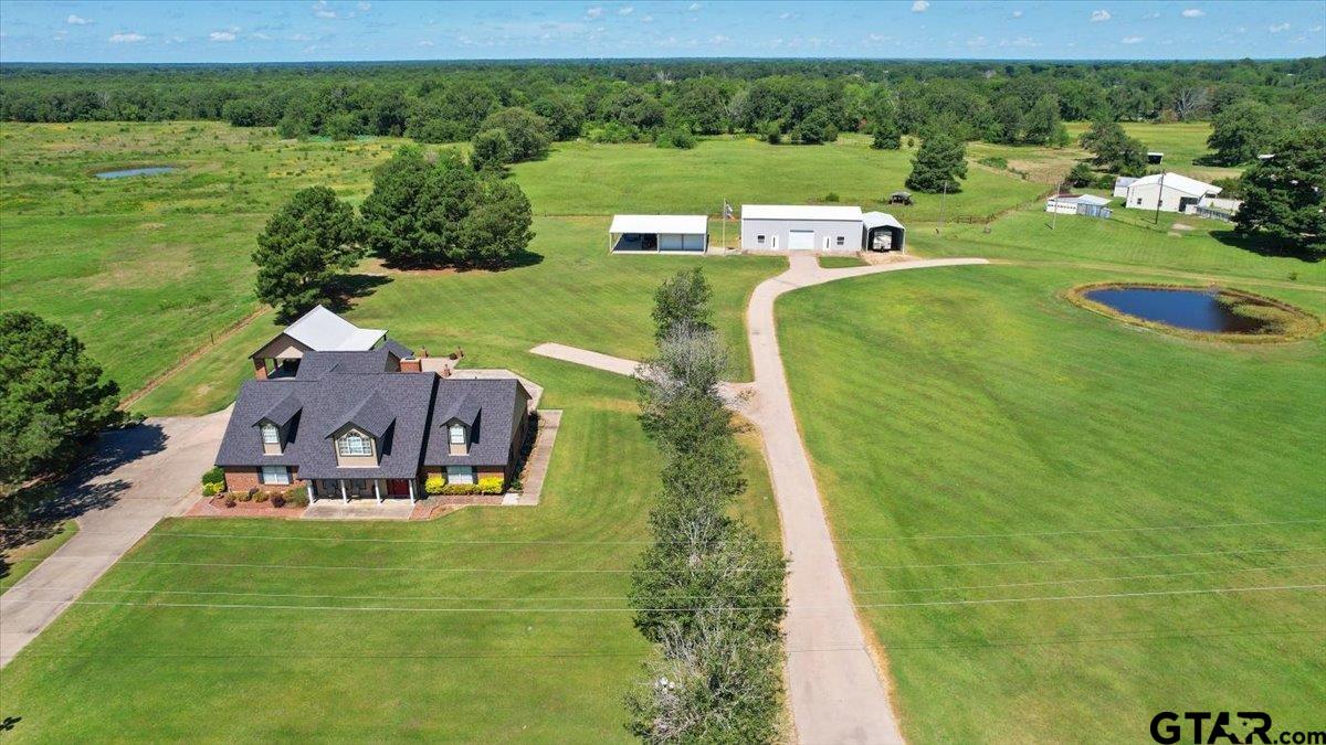 an aerial view of a house with a yard basket ball court and outdoor seating