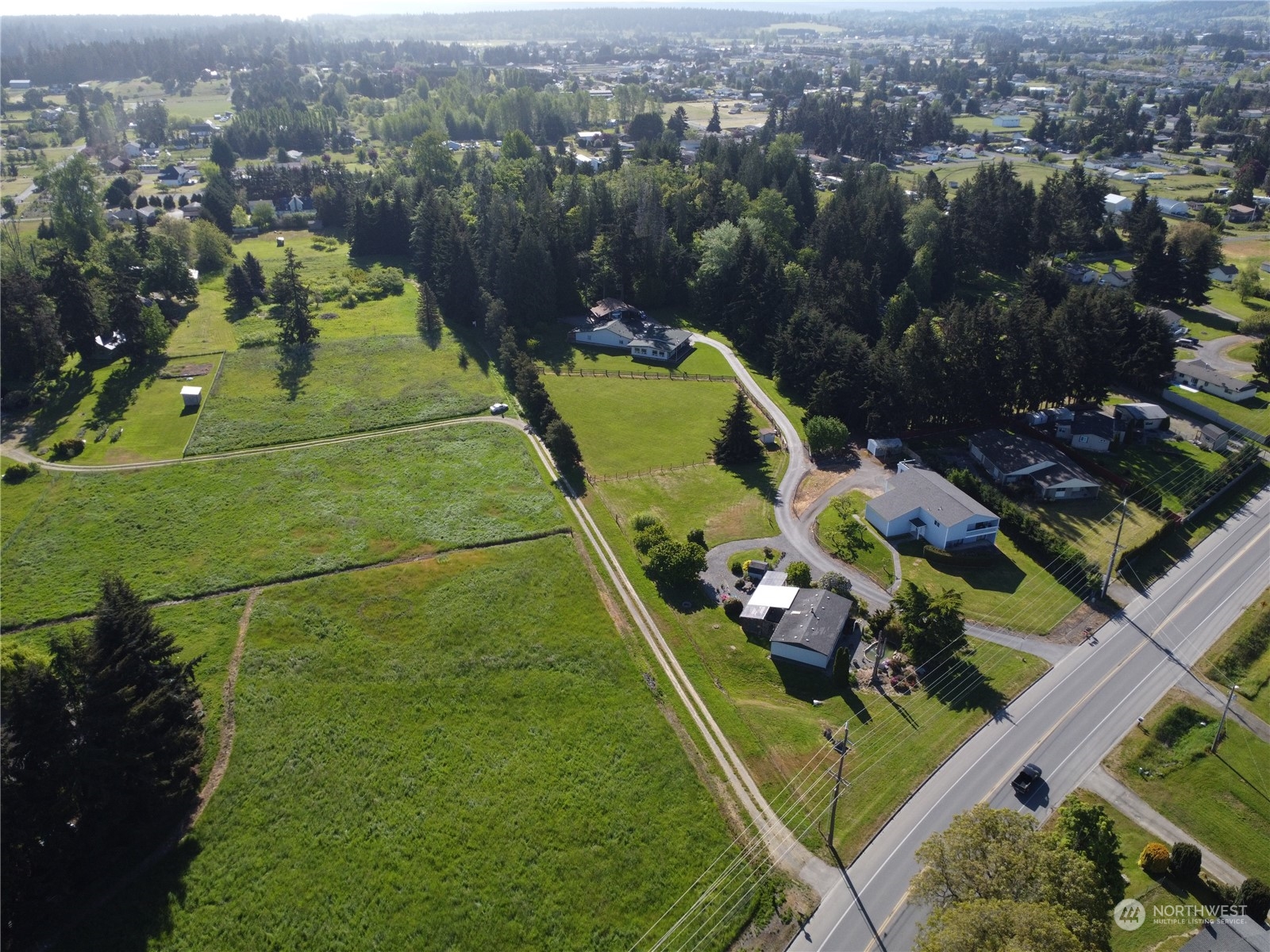 an aerial view of residential houses with outdoor space and a lake view