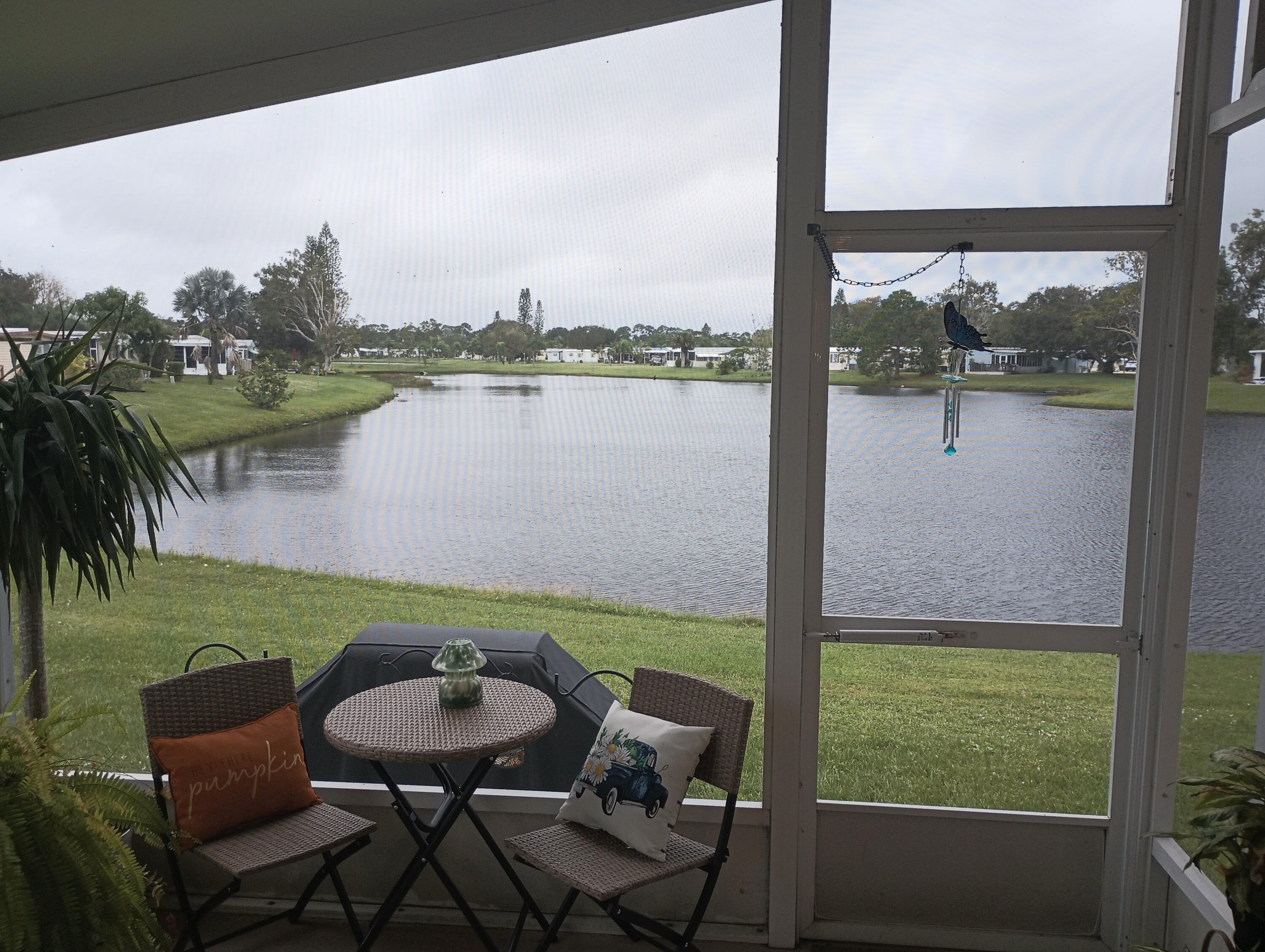 a balcony with furniture and a lake view