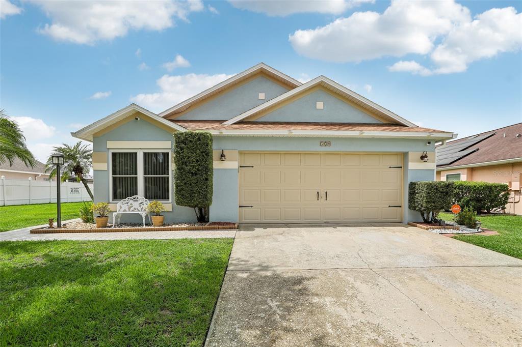 a front view of a house with a yard and garage