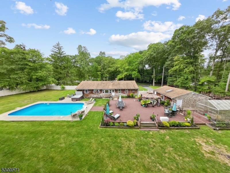 a view of a house with a yard patio and swimming pool