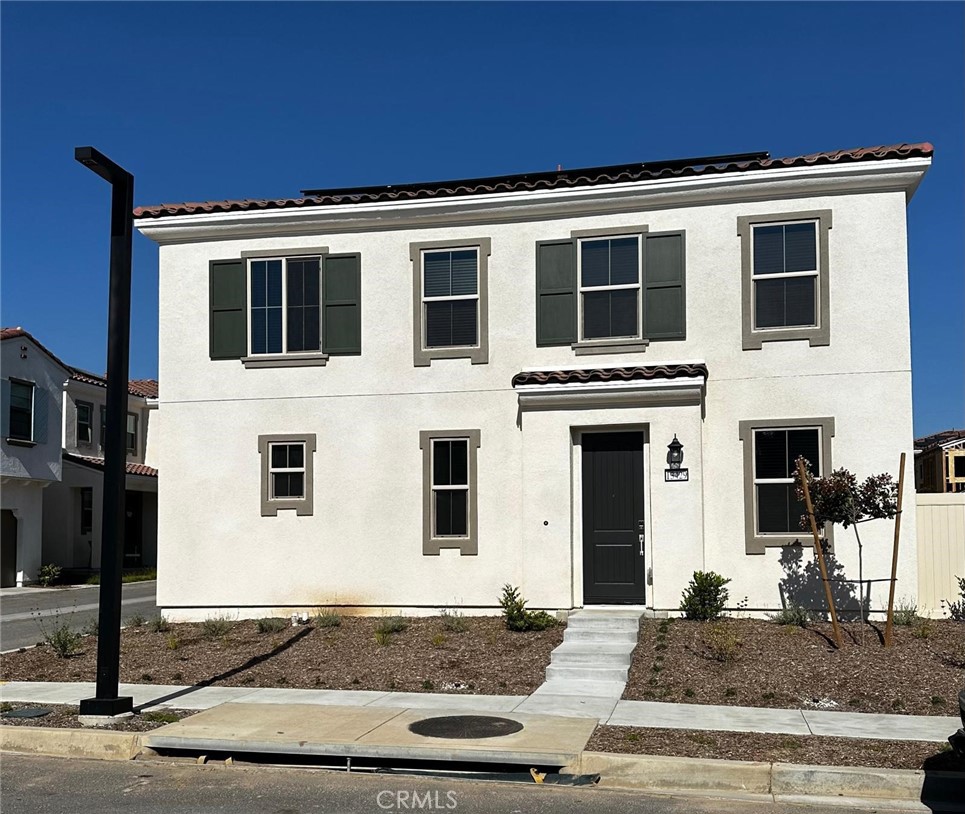 a front view of a house with windows and garage