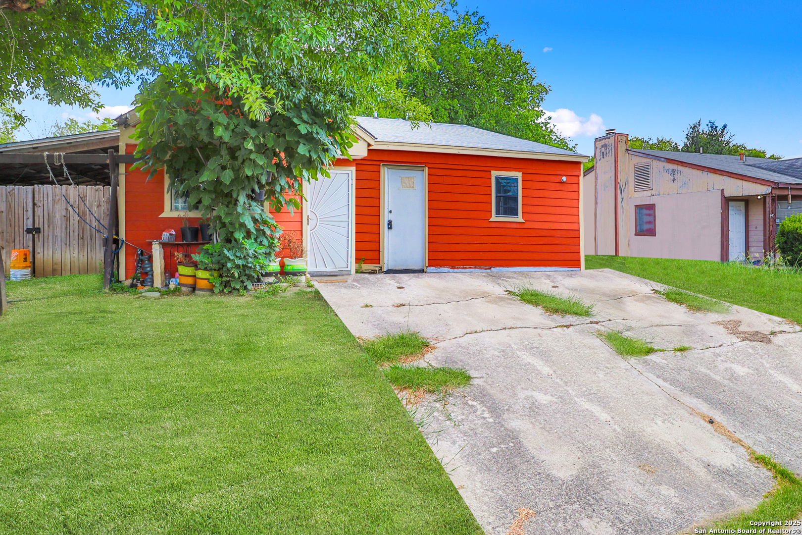 a front view of a house with a garden and yard