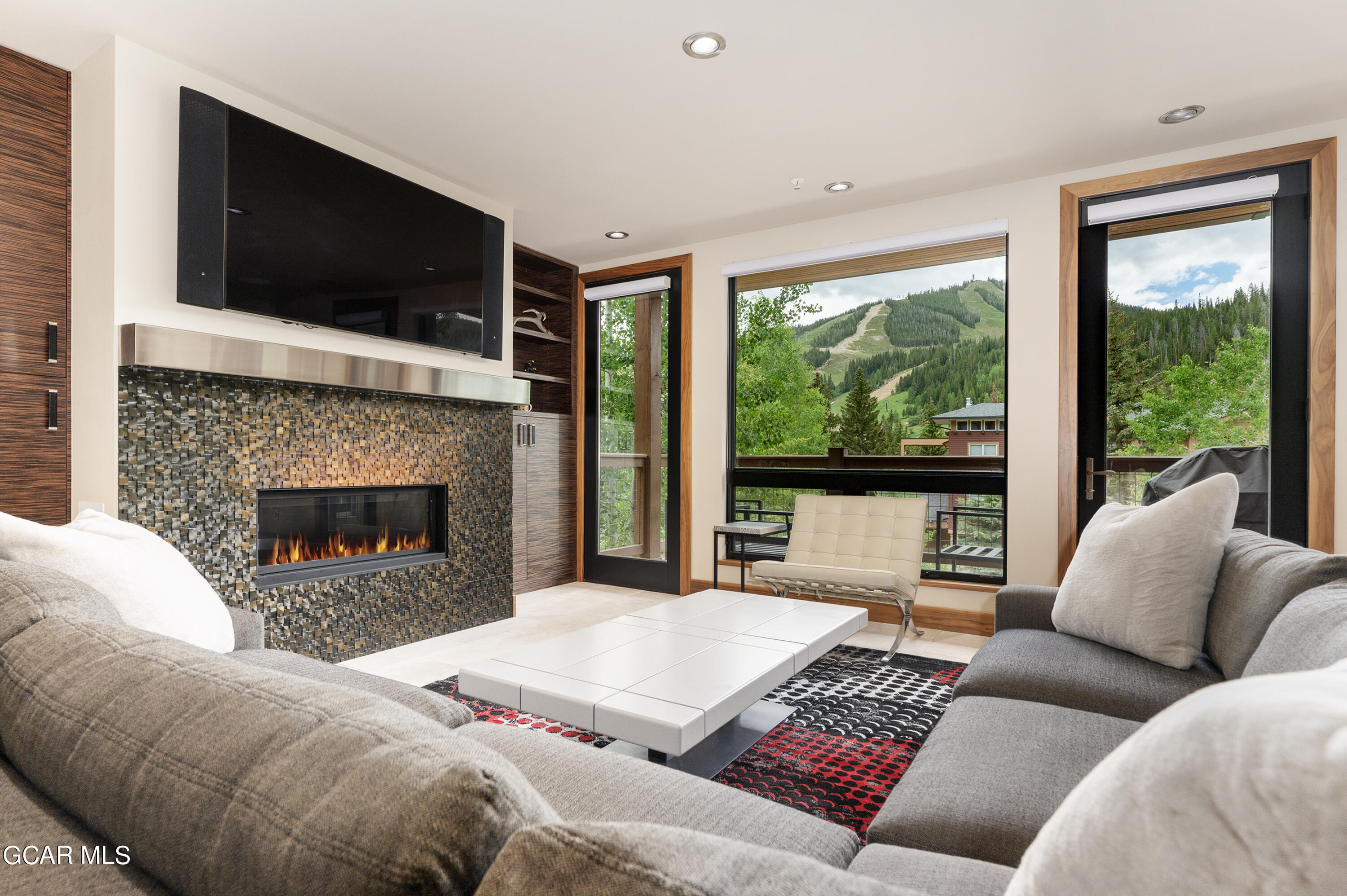 a living room with a fireplace and a flat screen tv