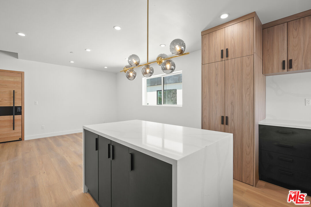 a kitchen with a sink a microwave and cabinets