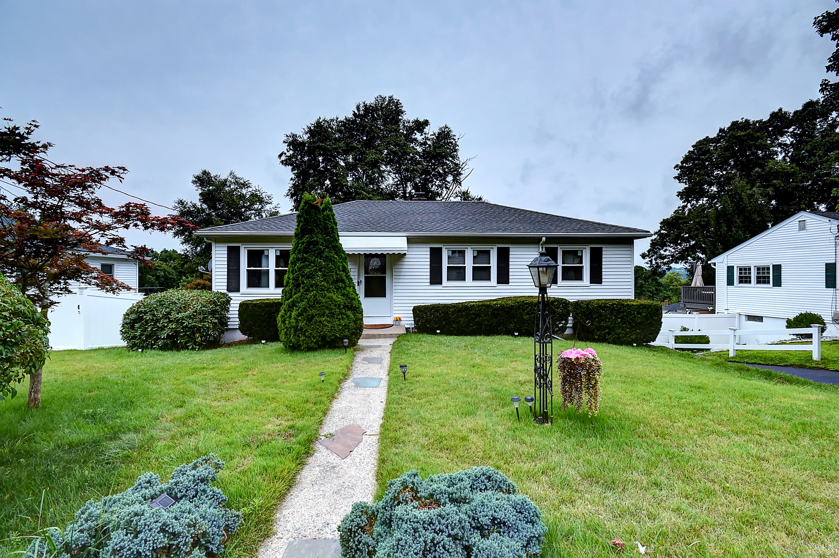 a house view with a sitting space and garden