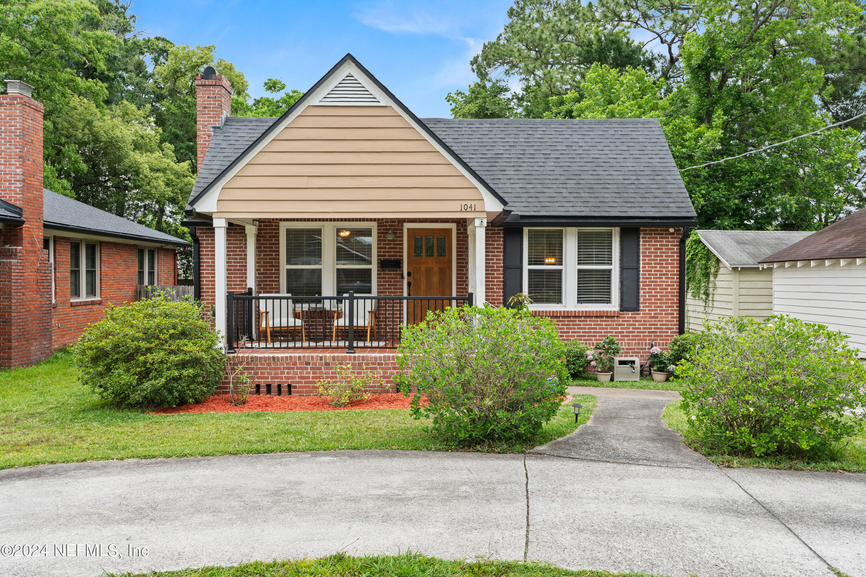 a view of a house with a yard and plants