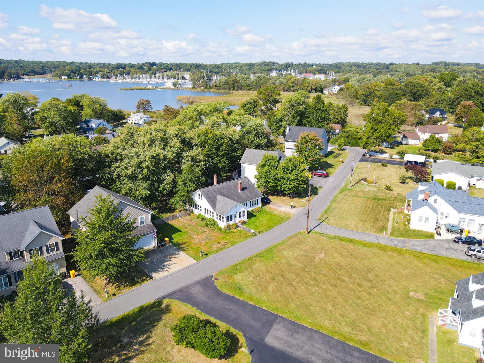 an aerial view of residential houses with outdoor space and swimming pool