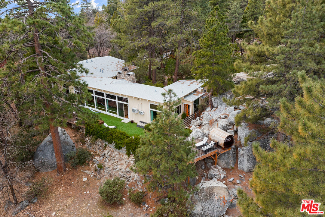 an aerial view of a house with a yard