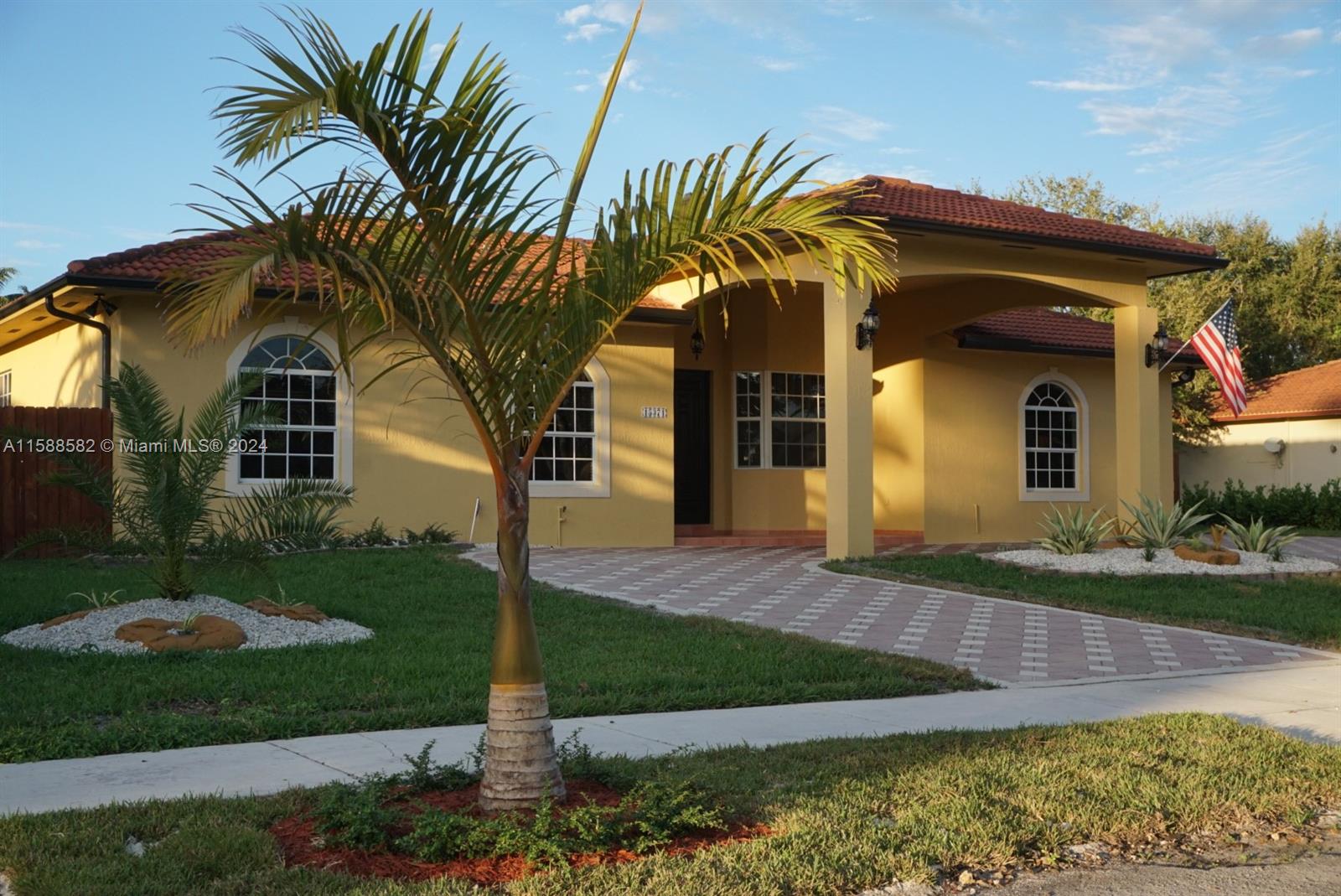 a front view of a house with garden