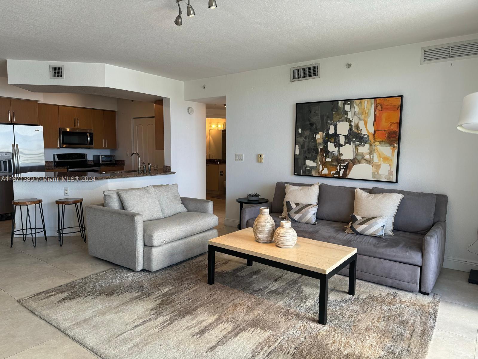 a living room with furniture and a rug