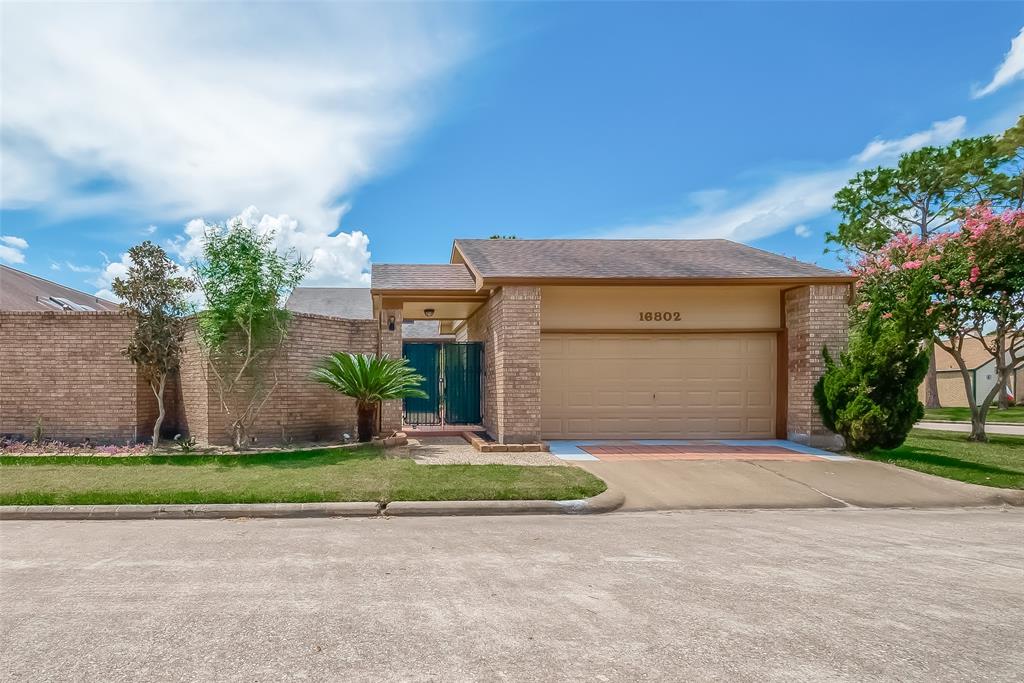 a front view of a house with a yard and a garage