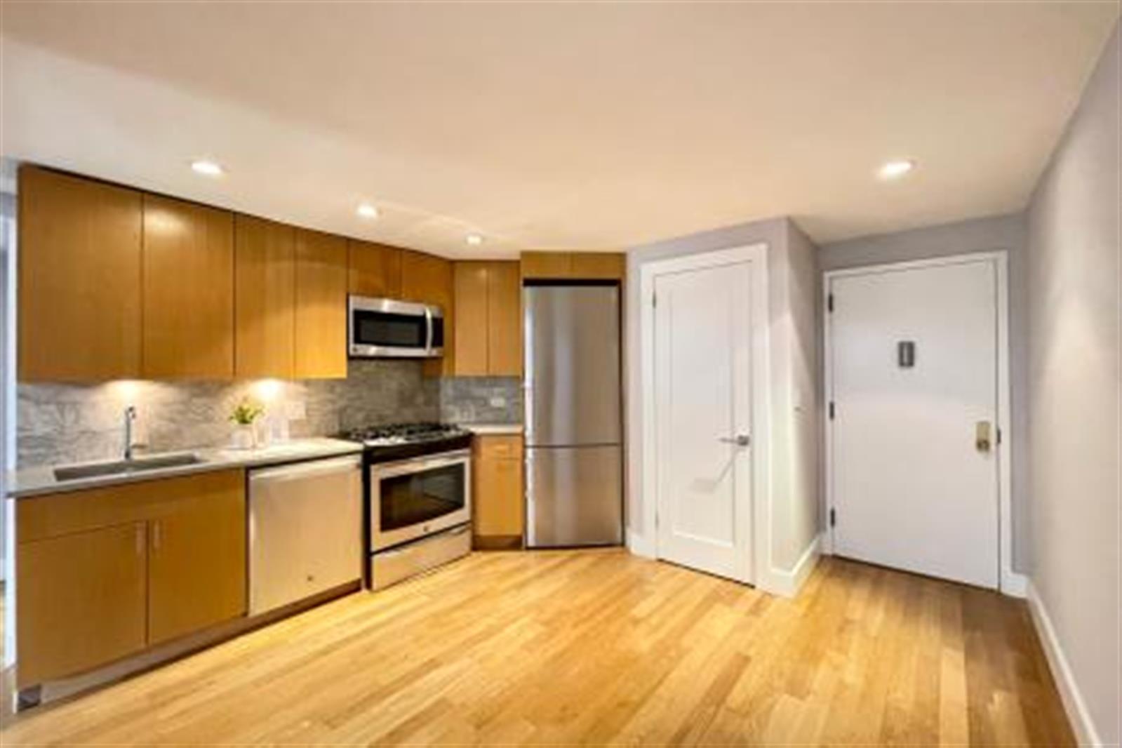 a kitchen with stainless steel appliances granite countertop a stove and a refrigerator