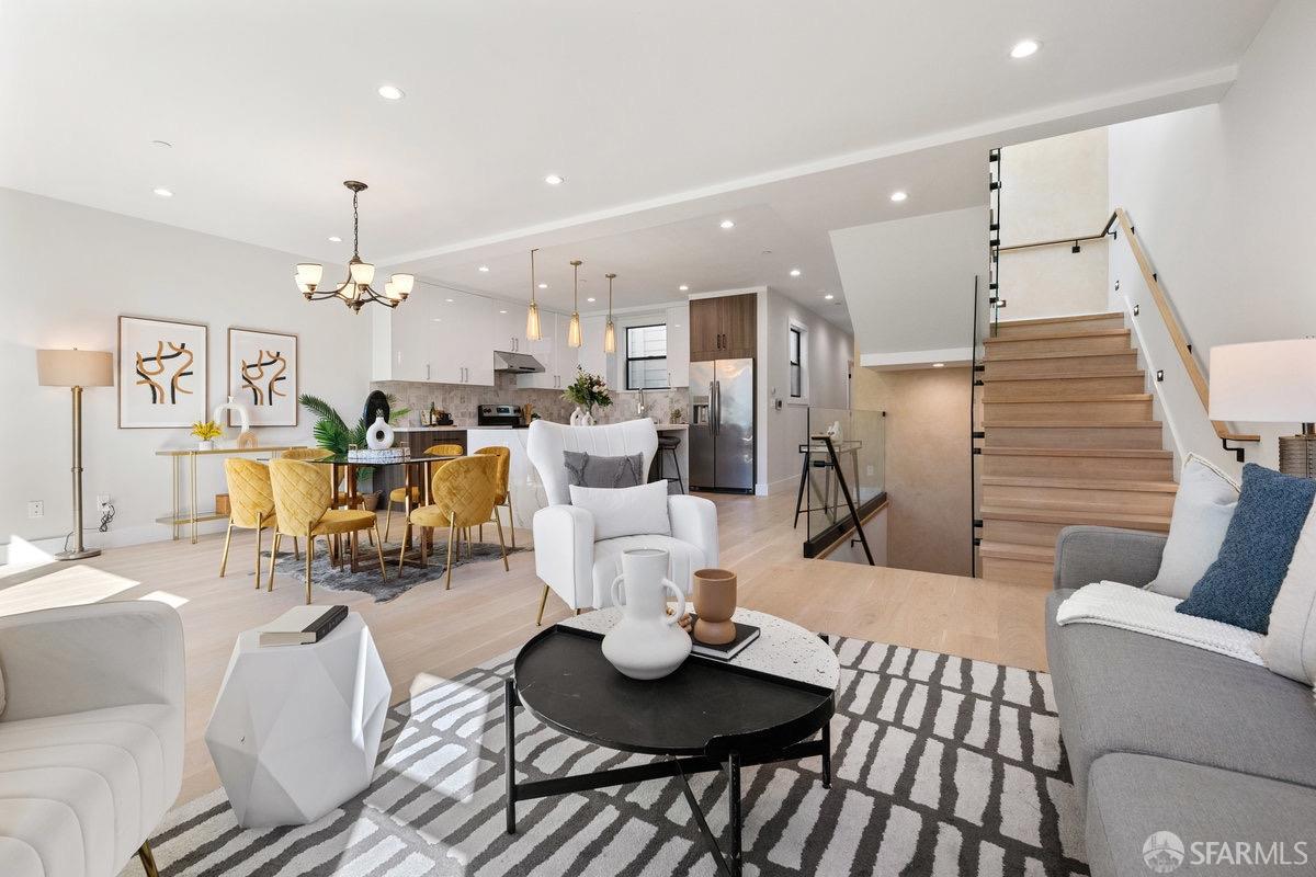 a living room with lots of furniture and kitchen view