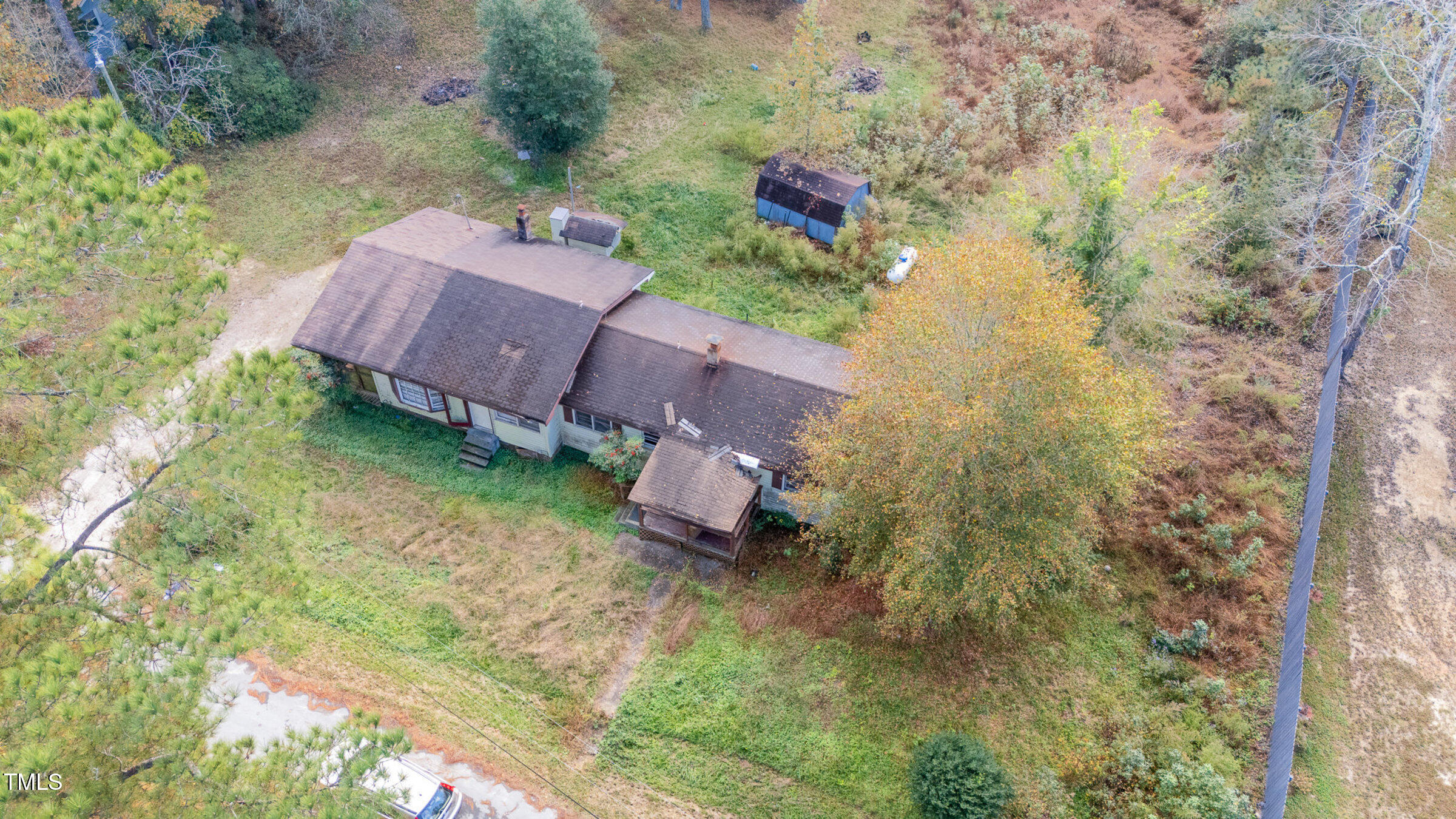 an aerial view of a house with garden space and street view