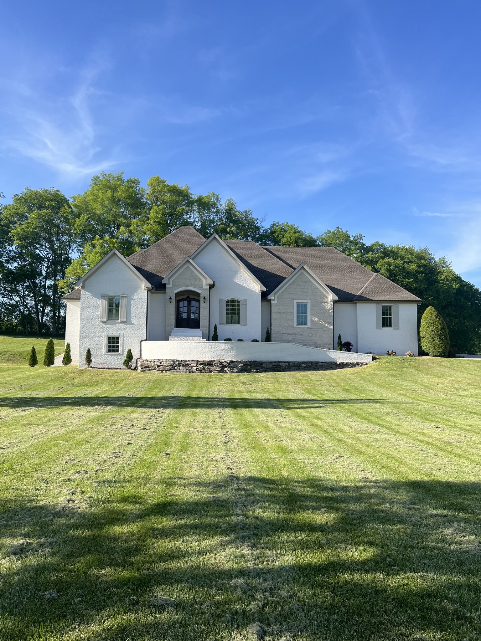 a front view of a house with a garden