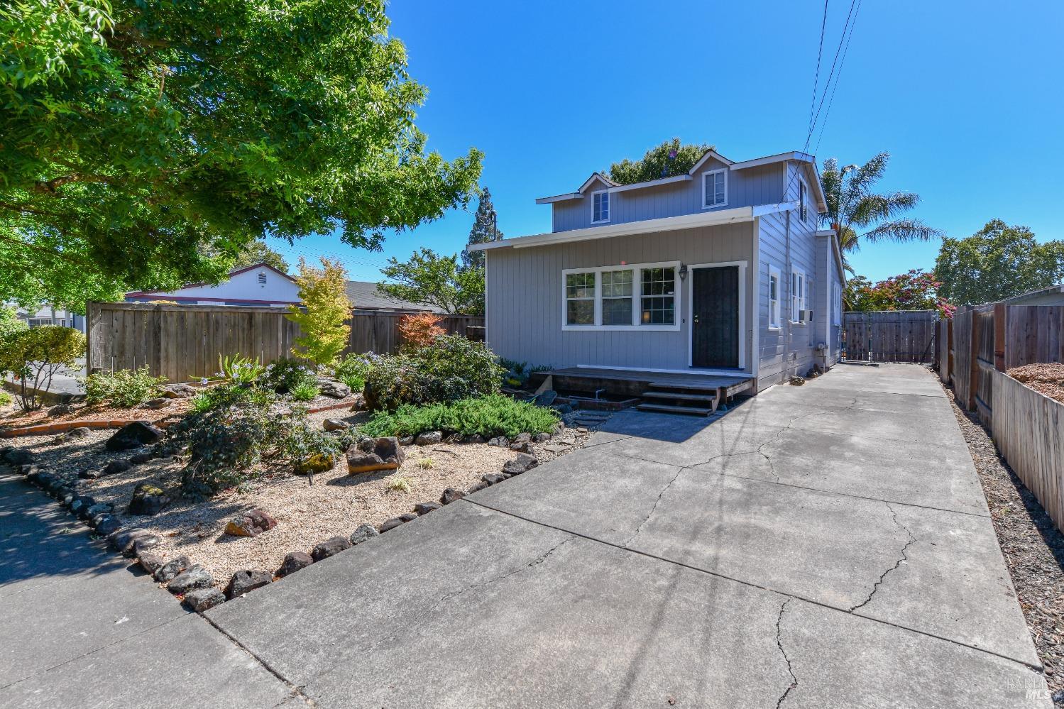 a view of a house with a small yard and plants