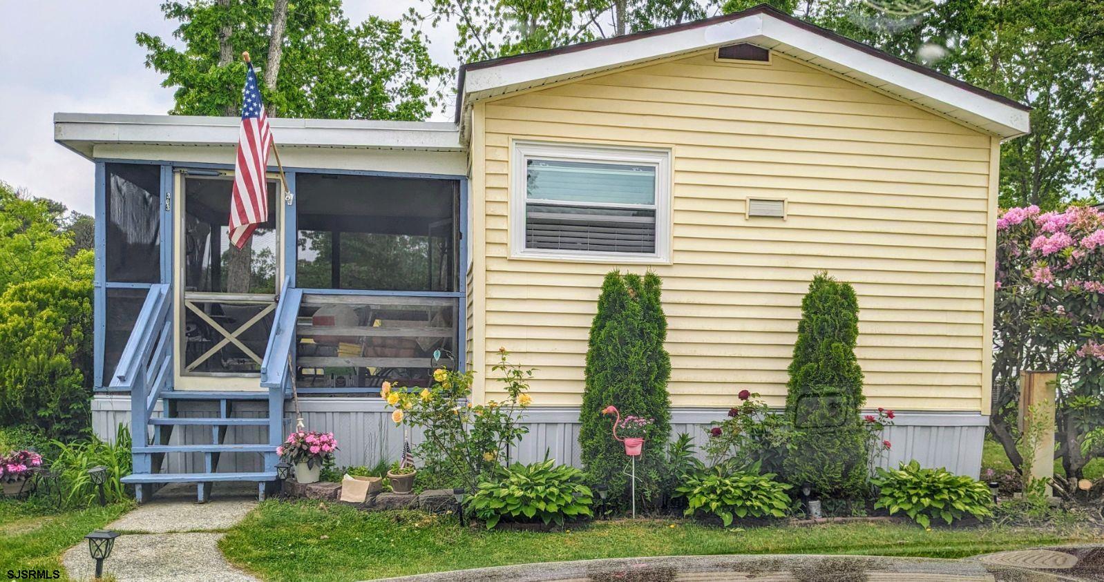 a front view of a house with plants