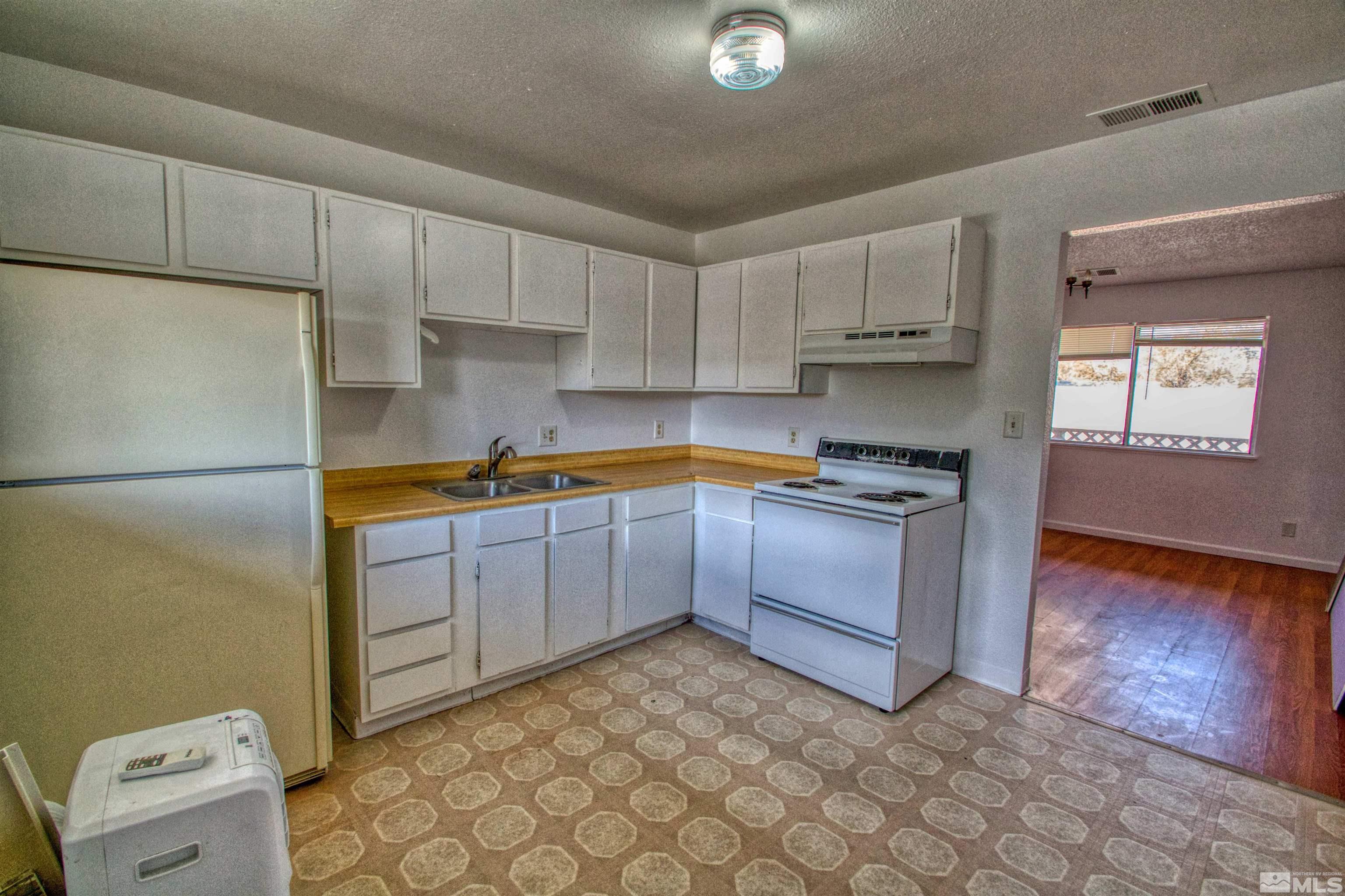 a kitchen with stainless steel appliances granite countertop a refrigerator sink and cabinets